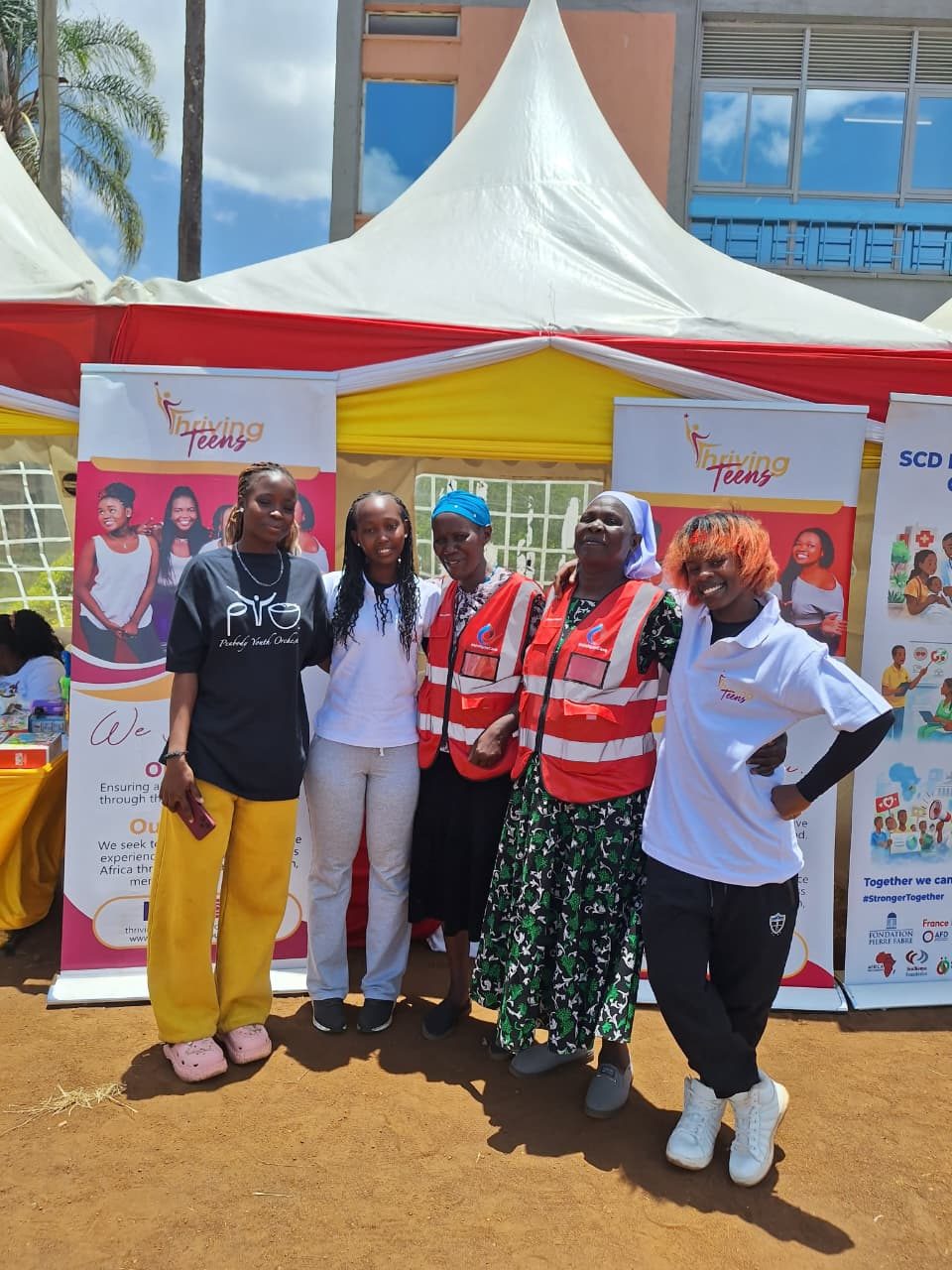 Thriving Teens team with community partners at an outreach tent