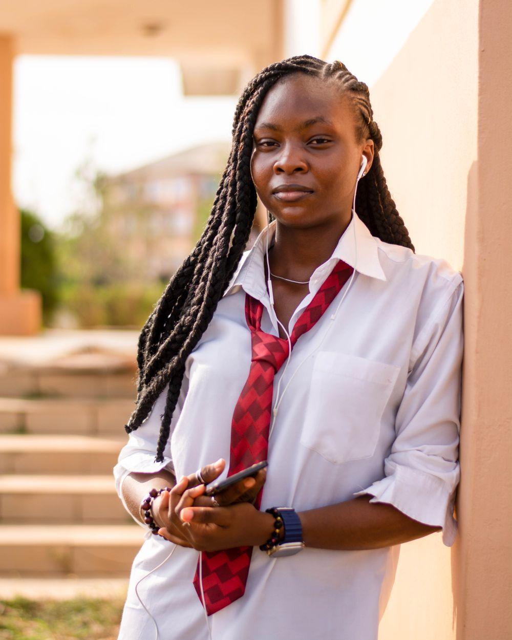 A confident teenage girl in school uniform