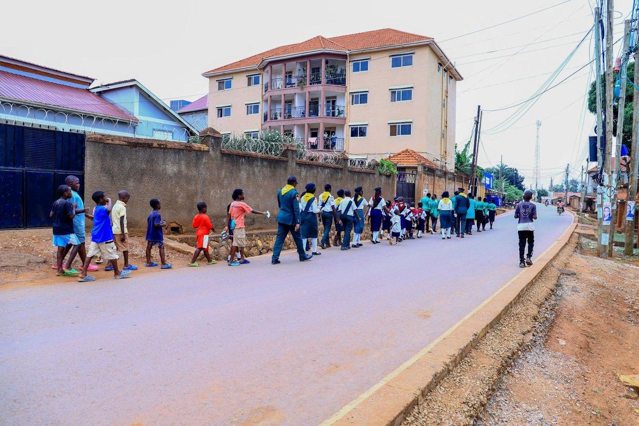 Children in school uniforms walking along a road to school