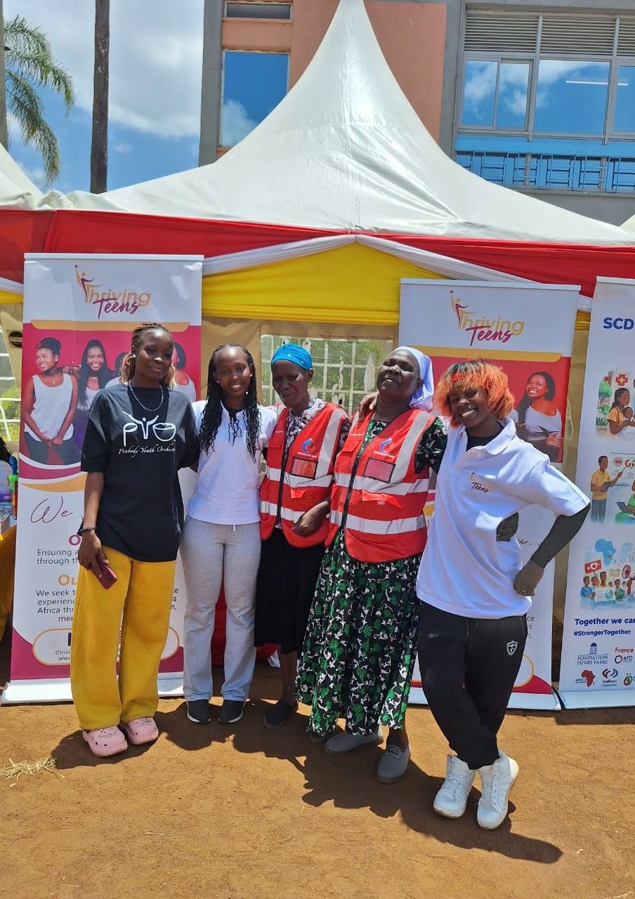 A Thriving Teens volunteer at the outreach banner